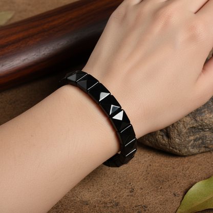 Hand wearing black crystal bracelet closeup